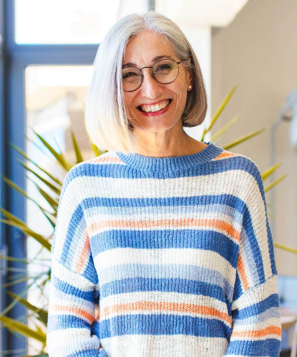 Portrait Photo of Senior Lady Wearing Glasses in an Open-Space Room at Stellar Living Communities