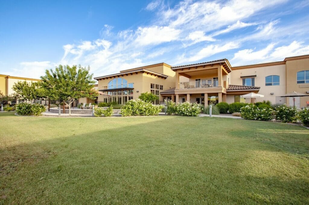 A large green lawn outside The Oaks.