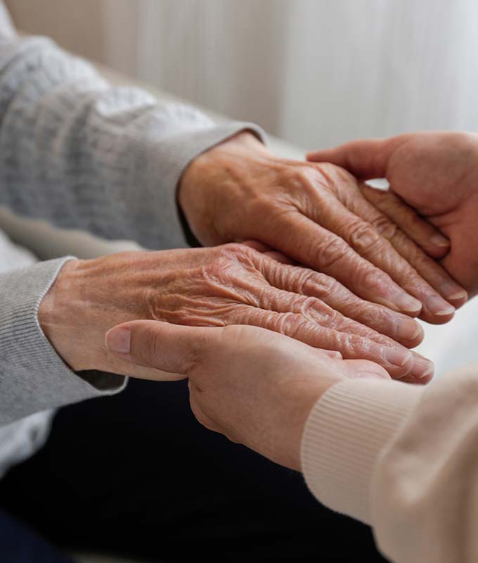 Young hands holding hands of an older person.