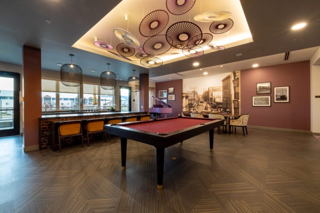 A pool table with custom art above