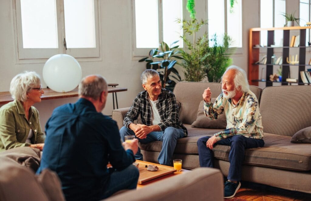 Seniors playing games and chatting at a senior living community