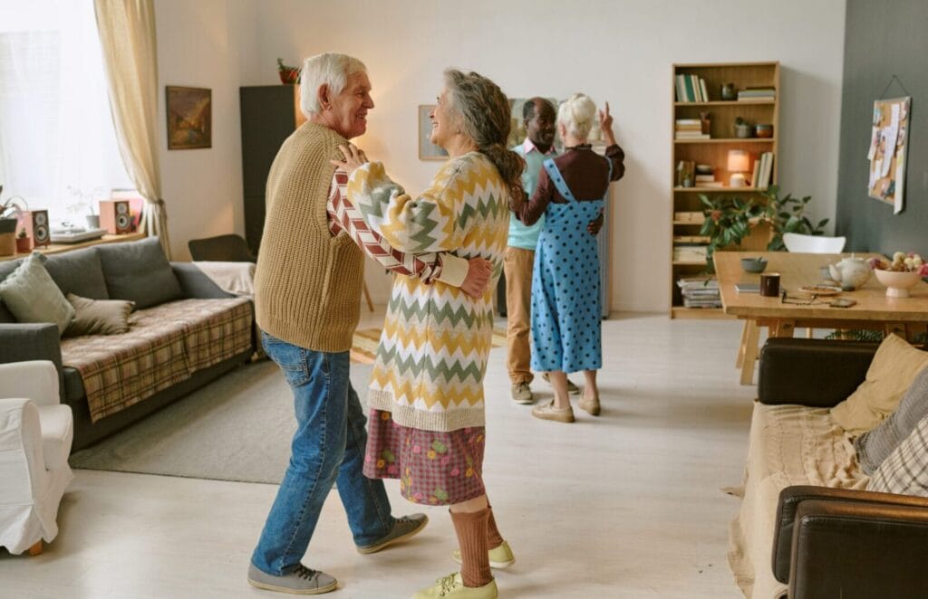 Seniors dance in a community area.