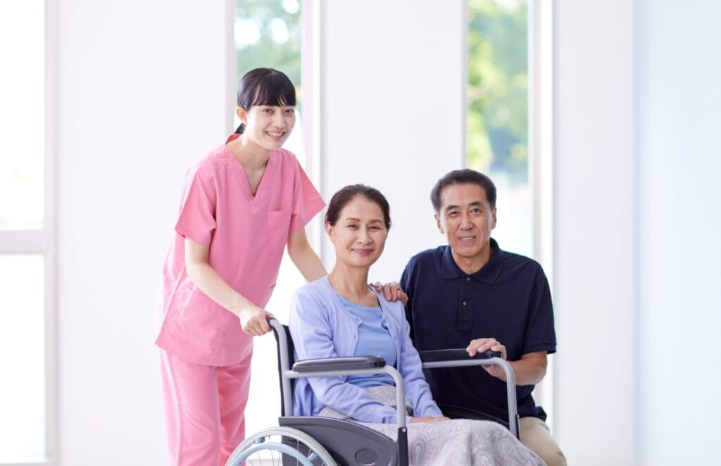 A senior in a wheelchair with her family.