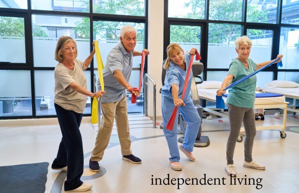 Independent living seniors use resistance bands to exercise.