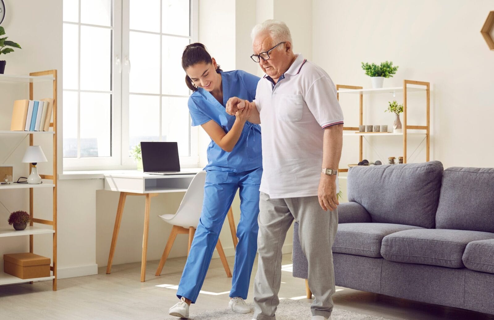A nurse helps a senior citizen in an assisted living or memory care community.
