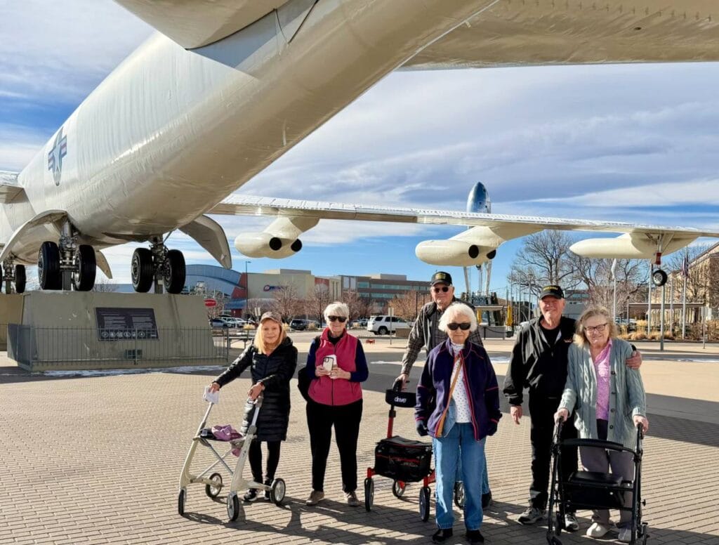 Denver Senior Living residents underneath an airplane