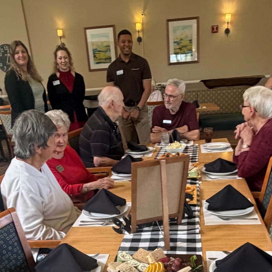 Independent seniors at Broadway Proper Senior Living enjoy dinner with friends