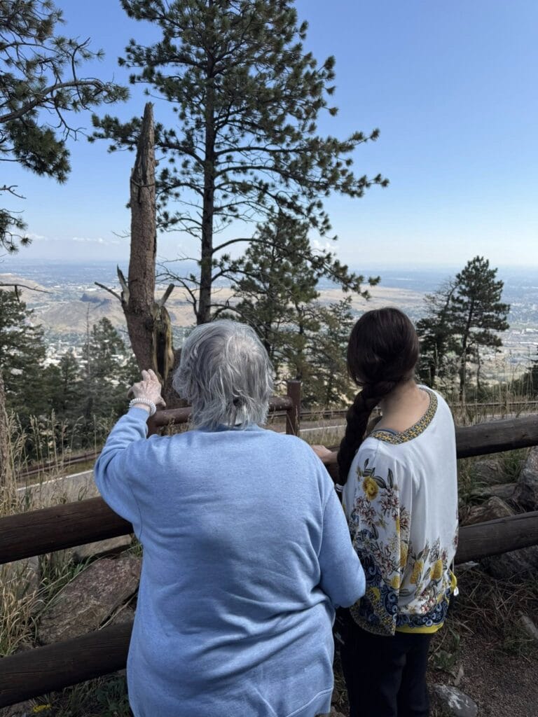 Seniors look out at a view of trees and Denver at one outing at Lakewood Reserve