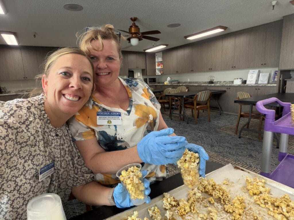 Staff members making caramel corn at Lincoln Court