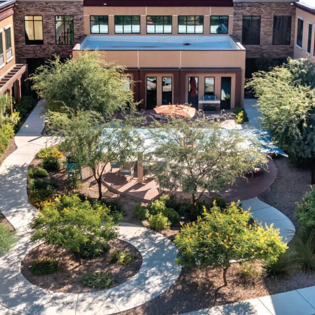 22-OVO-Exterior-Drone-0205-4C (2) Copper Creek Senior Living South Jordan Utah front entrance at sunset